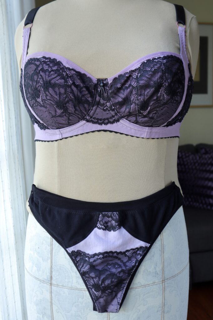 Purple and black lace bra and underwear set on mannequin