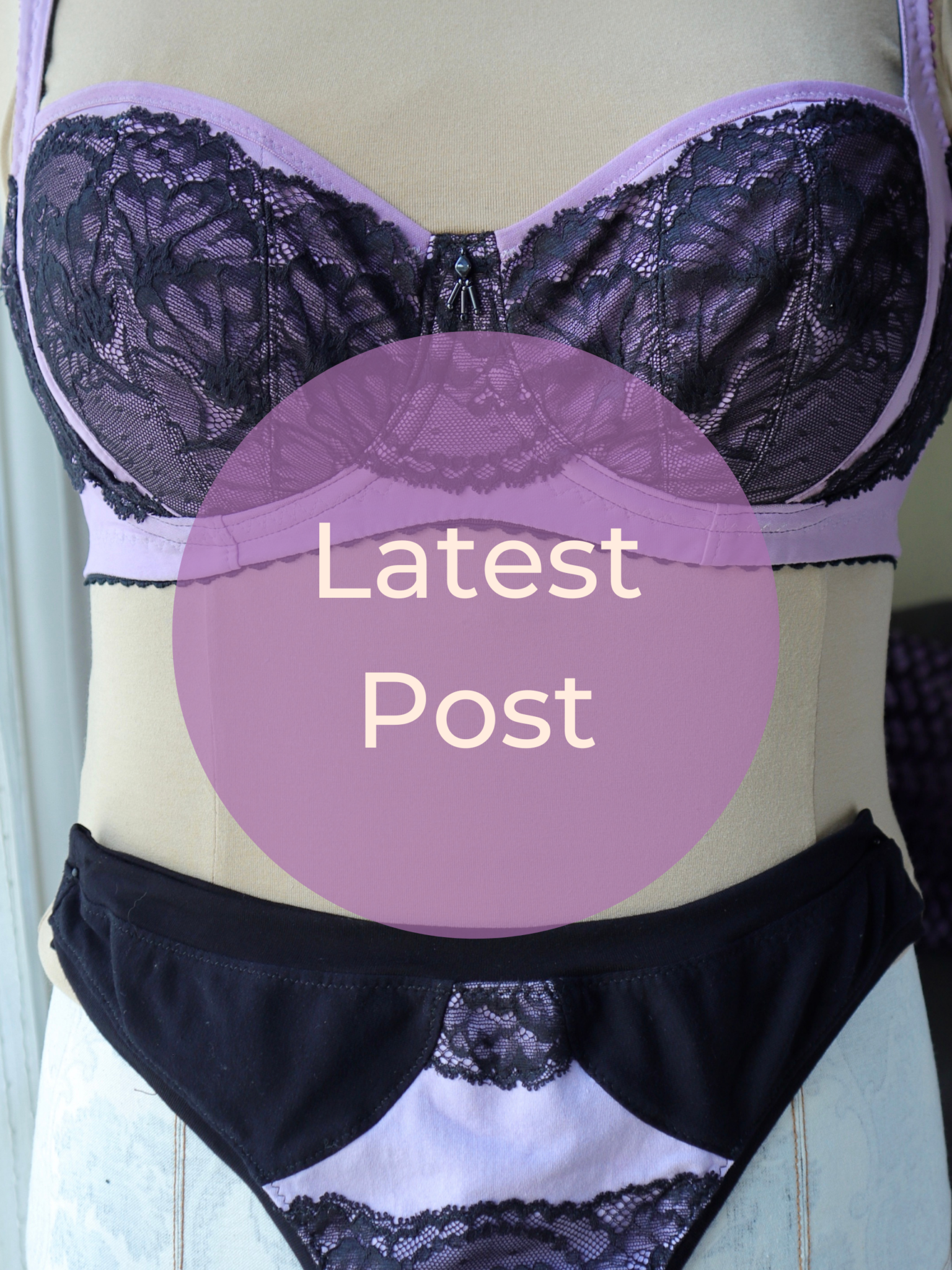 Close up of purple bra and underwear with black lace. A purple circle in the centre reads 'Latest Post'.