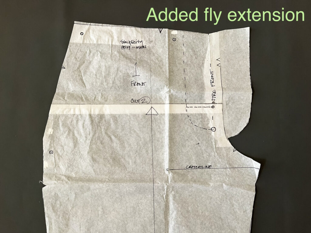 Detail of front pant pattern piece with writing "Added fly extension"