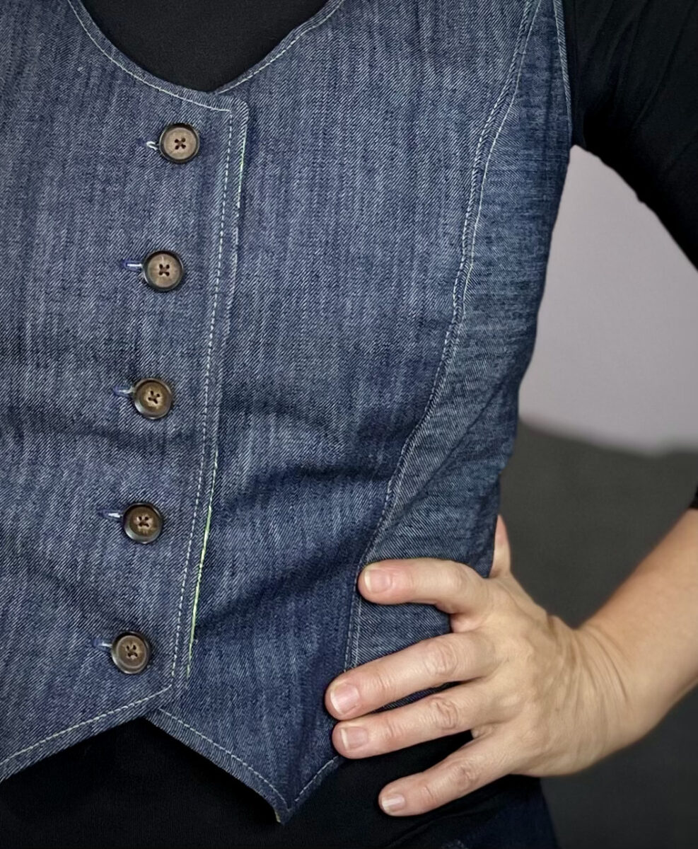 Close up of denim vest with tortoise shell buttons